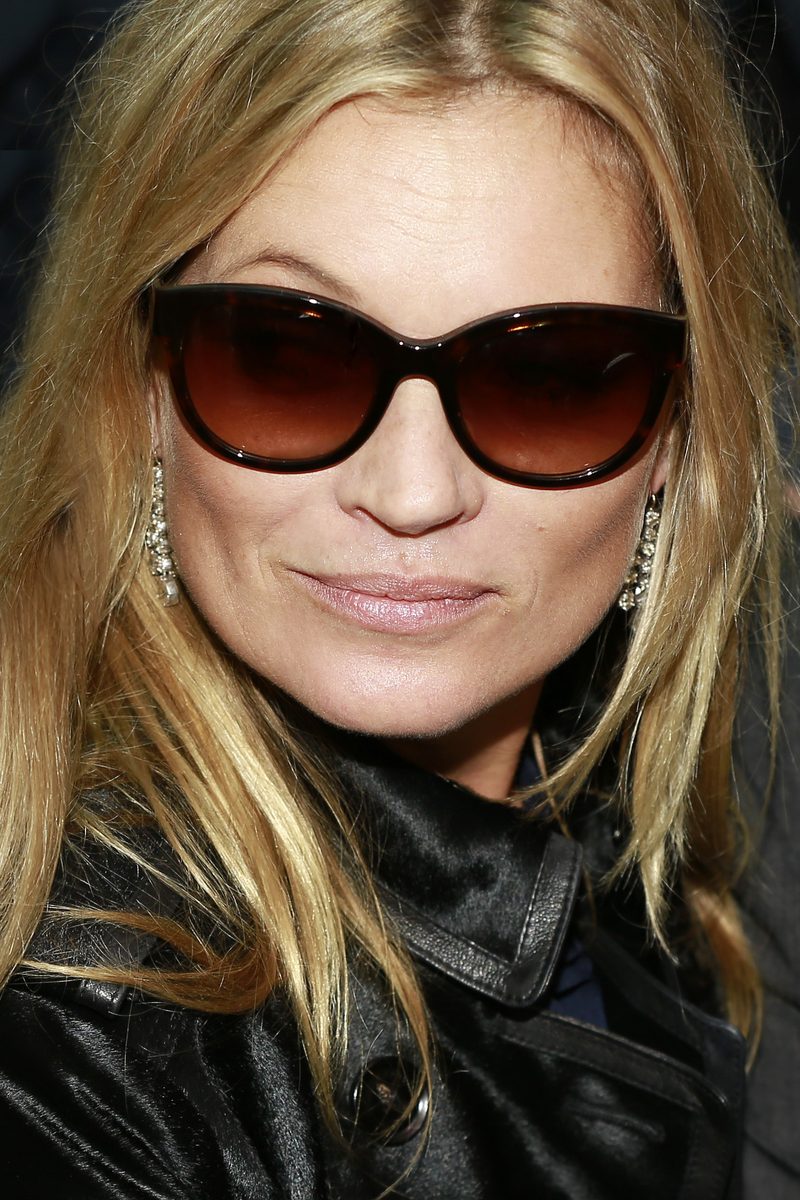 Kate Moss in dark sunglasses and a black leather jacket at London Fashion Week 2014