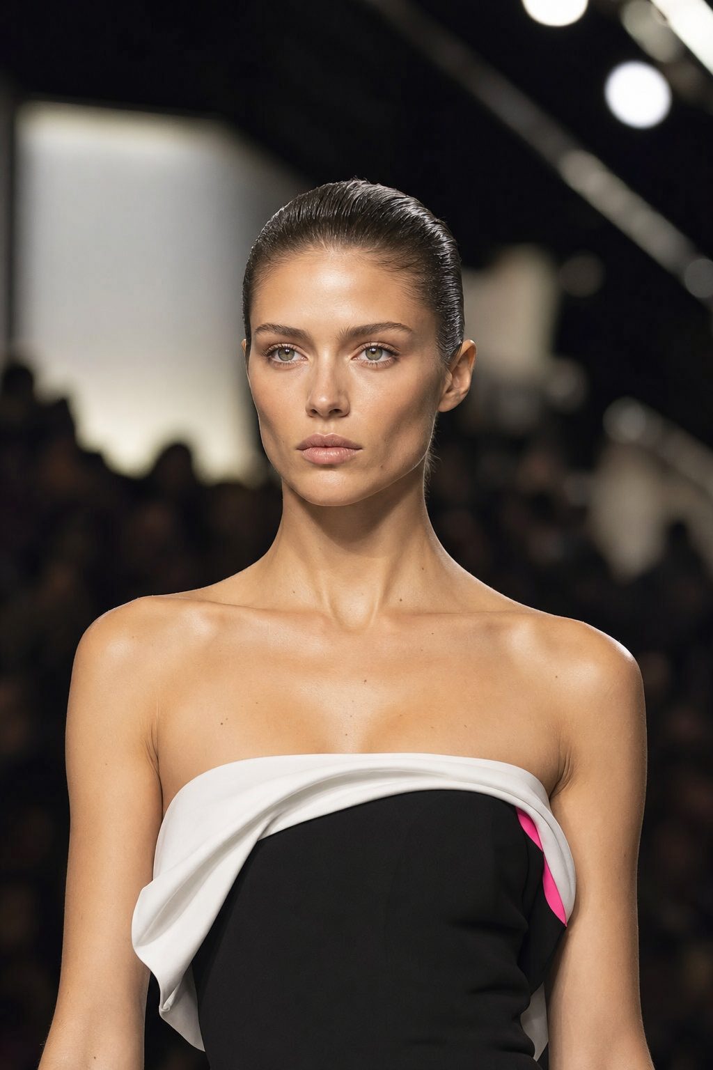 Model's face on the runway: calm, focused gaze straight ahead