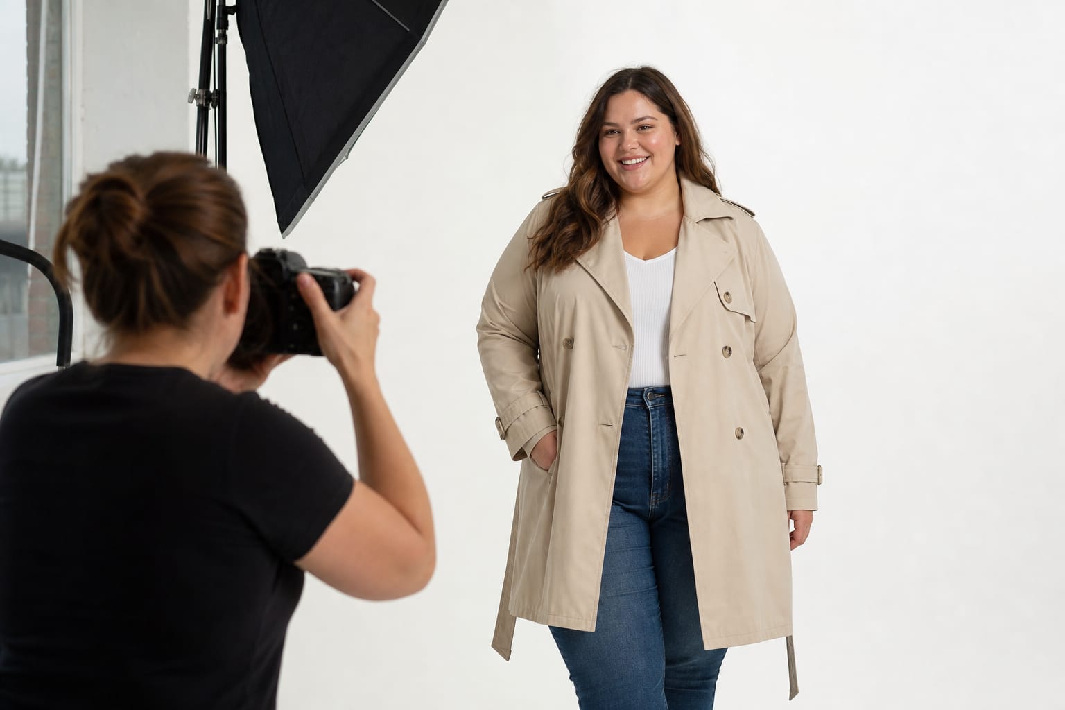 A plus size model in a beige trench coat photographed for an e-commerce catalogue